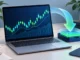 Laptop with a financial chart and a visual download and installation element